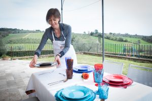 Barbara sets the table in her home in Siena, Tuscany