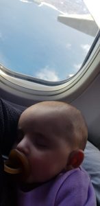 Eliana sleeping on her plane ride at 5 months