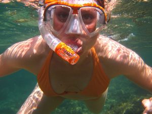 Woman in orange swimmers and snorkels