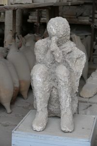 A plaster cast of a victim curled up made from the Pompeii ruins