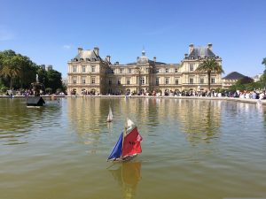 Relax at  Luxembourg Gardens in Paris as kids enjoy sailing boats around the fountain