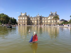 Relax at Luxembourg Gardens in Paris as kids enjoy sailing boats around the fountain